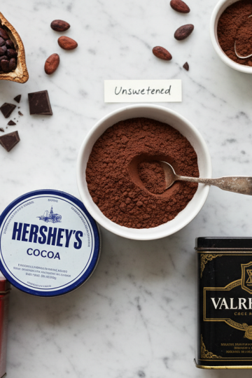 Natural cocoa powder brands in bowls on a marble countertop