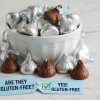 Pile of silver-foil Hershey's Kisses chocolates spilling from a bowl