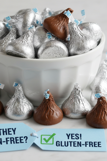 Pile of silver-foil Hershey's Kisses chocolates spilling from a bowl