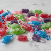Colorful assorted Jolly Rancher hard candies scattered on white marble
