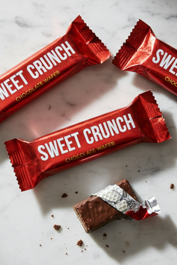 Chocolate wafer candy bars on a white marble countertop