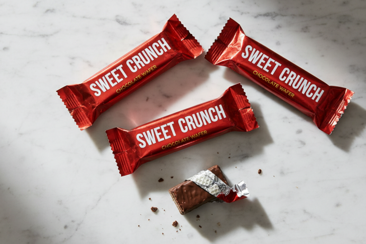 Chocolate wafer candy bars on a white marble countertop
