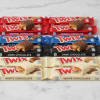 Twix candy bars — original, dark chocolate, and white chocolate varieties on a white marble surface