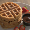 Golden churro waffles stacked with cinnamon sugar and chocolate dipping sauce