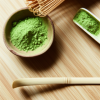 ceremonial grade matcha powder in ceramic bowl with bamboo whisk gluten free