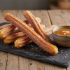 golden crispy salted caramel churros with cinnamon sugar and caramel dipping sauce